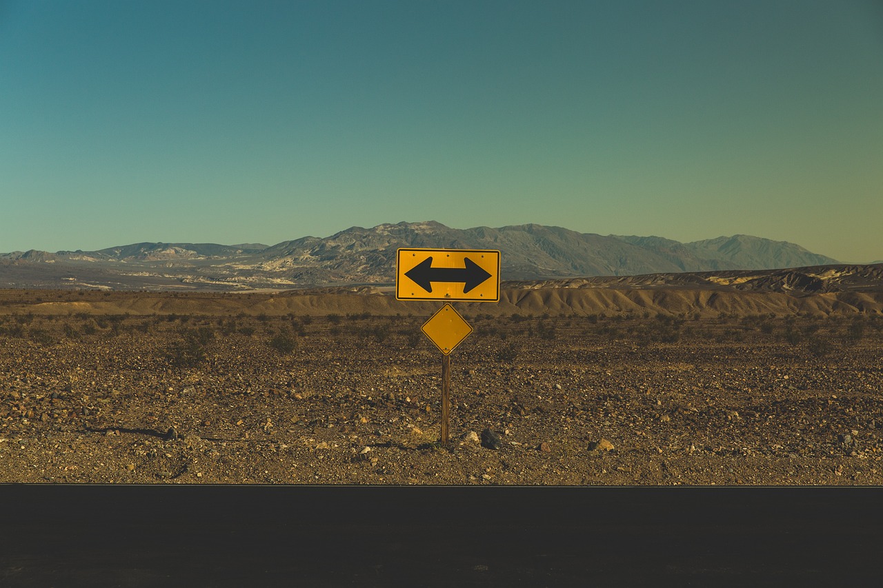 arrows barren direction road road sign street left right desert nature landscape arid dry land rural countryside