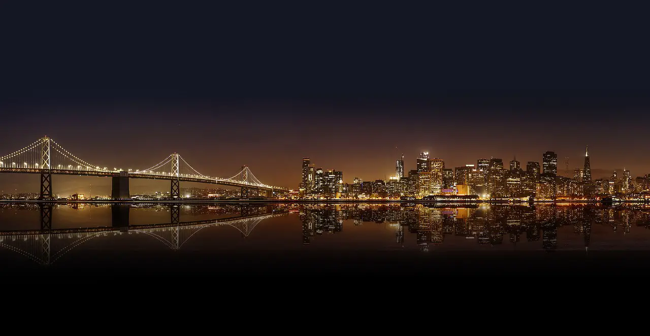architecture bridge buildings nature city city lights cityscape downtown night panoramic reflection sea skyline skyscrapers suspension bridge urban water usa america illuminated water reflection mirroring mirror image