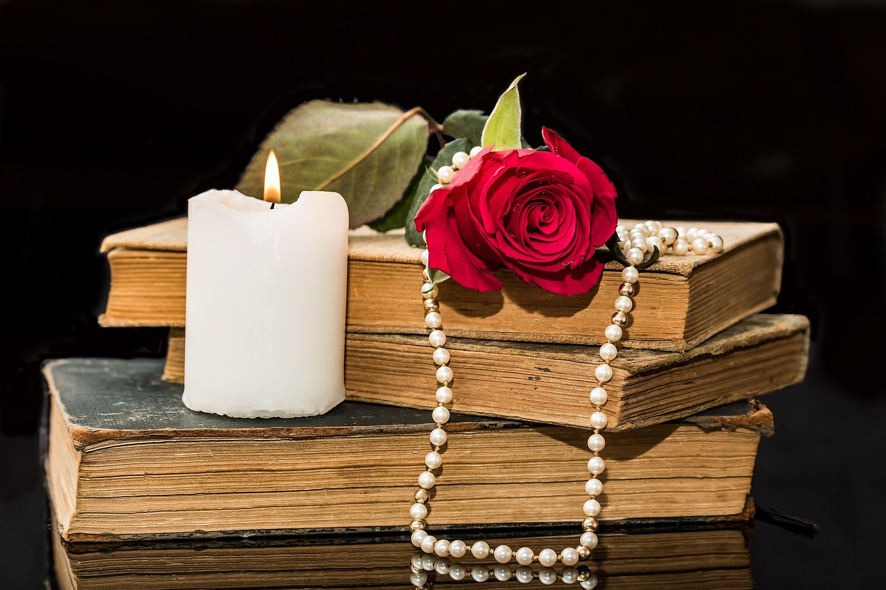 old books rose flower rose red rose candle pearl necklace blossom bloom nostalgic past old romantic light candlelight string of pearls