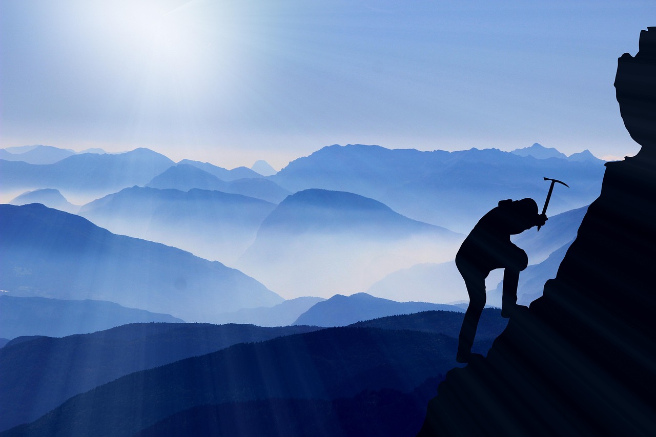 climb mountaineering mountains mountain ranges mountaineer nature mountain climber mountain climbing cliffs silhouette rock formations ice ax summit sunrise sunbeam